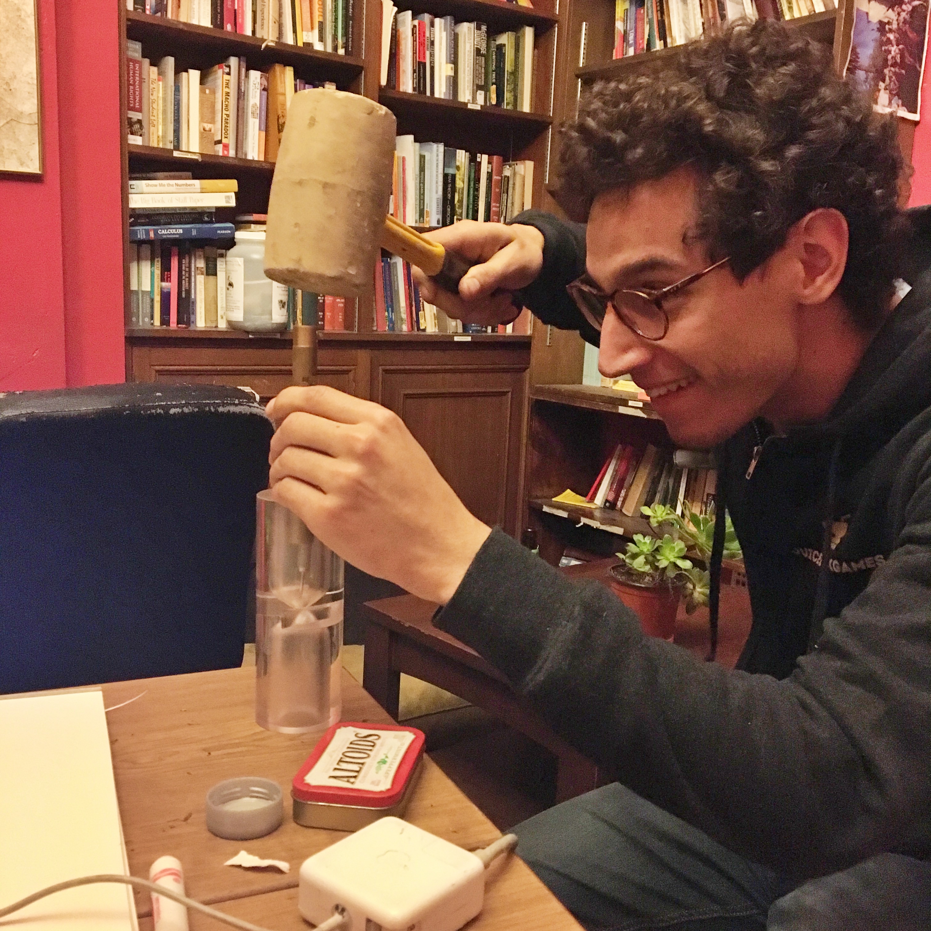 Making the final hole through the hourglass with the tip of a dart and a mallet